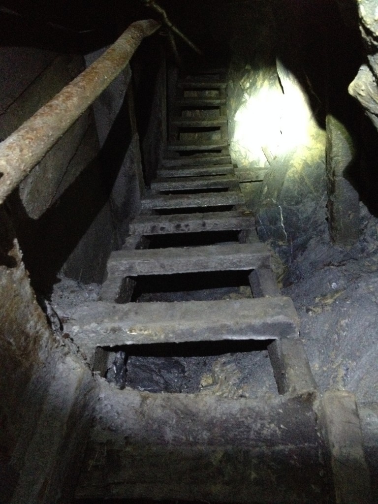 Wooden stairs leading to the top of an ore chute. The stairs are about 30+ feet high